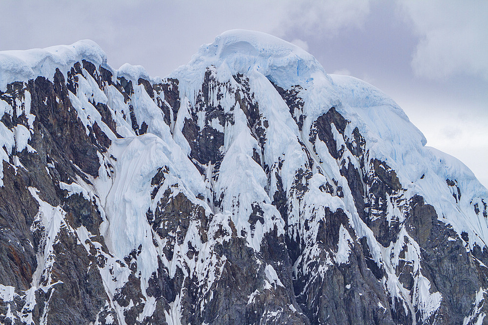 Snow-covered mountains in Crystal Sound, south of the Antarctic Circle, Antarctica, Southern Ocean.