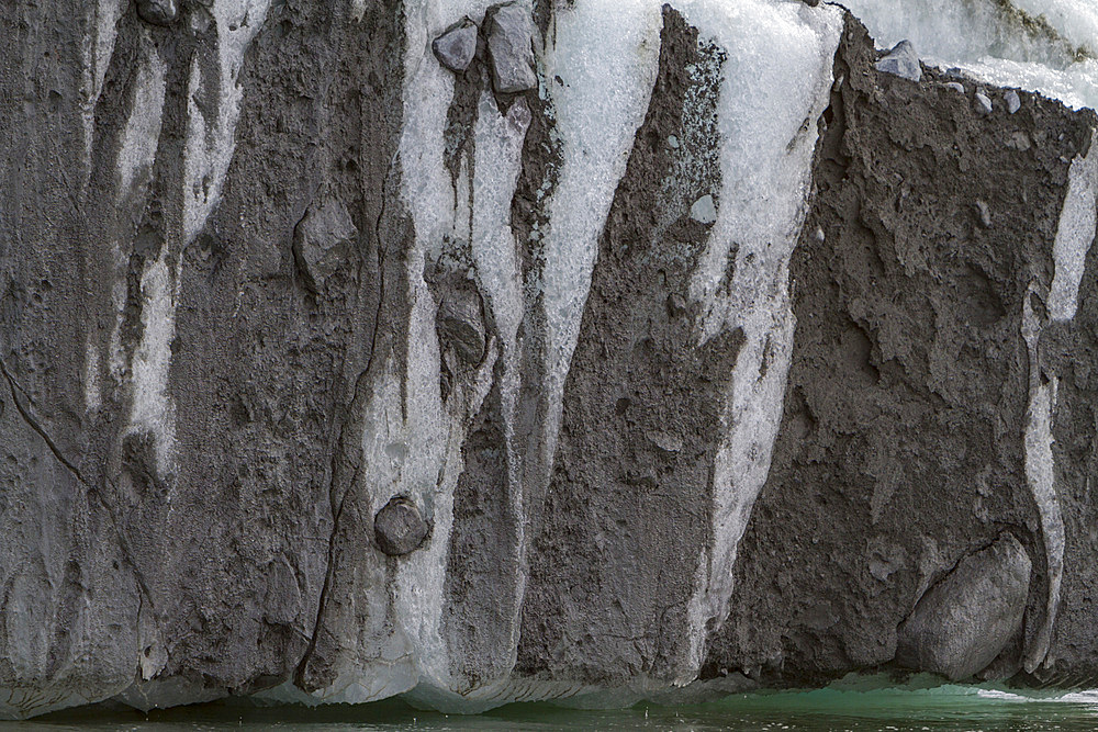 Iceberg detail showing the moraine layer around the Antarctic Peninsula, during the Austral summer months, Antarctica.