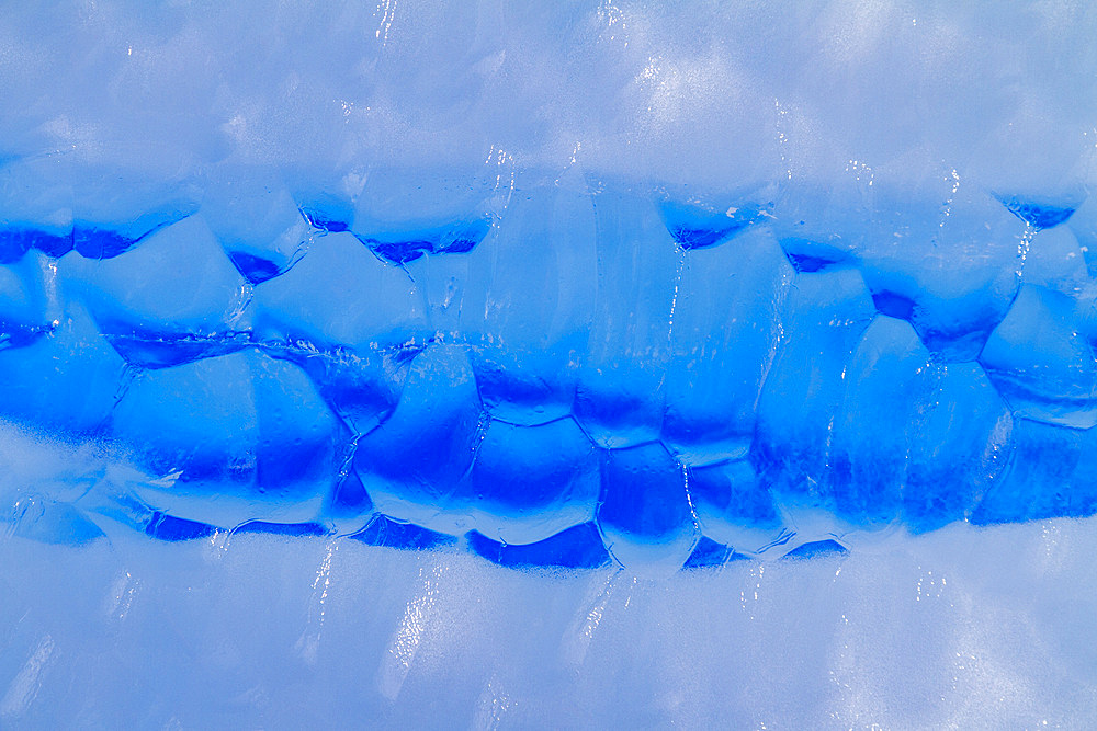 Iceberg detail showing the color blue around the Antarctic Peninsula, during the Austral summer months, Antarctica.