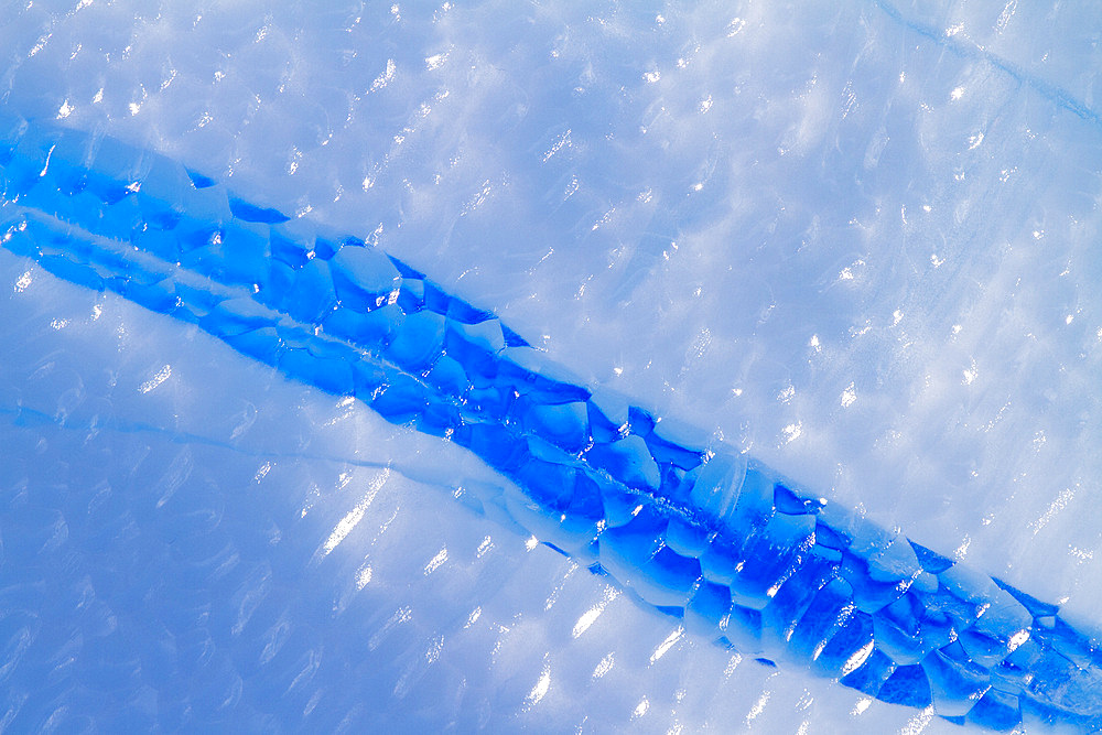 Iceberg detail showing the color blue around the Antarctic Peninsula, during the Austral summer months, Antarctica.