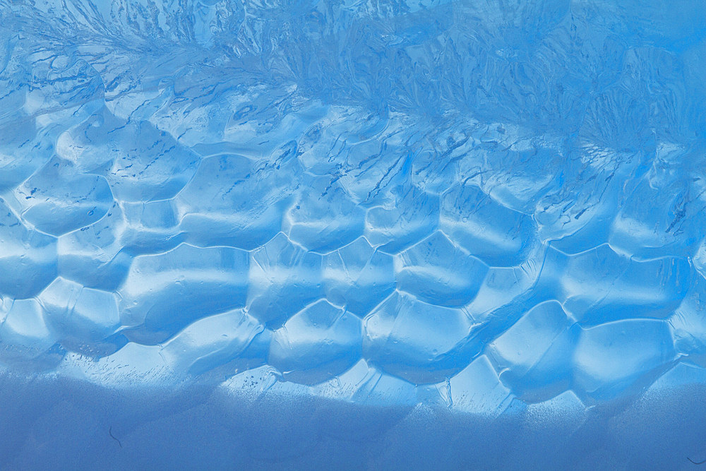 Iceberg detail showing the color blue around the Antarctic Peninsula, during the Austral summer months, Antarctica.