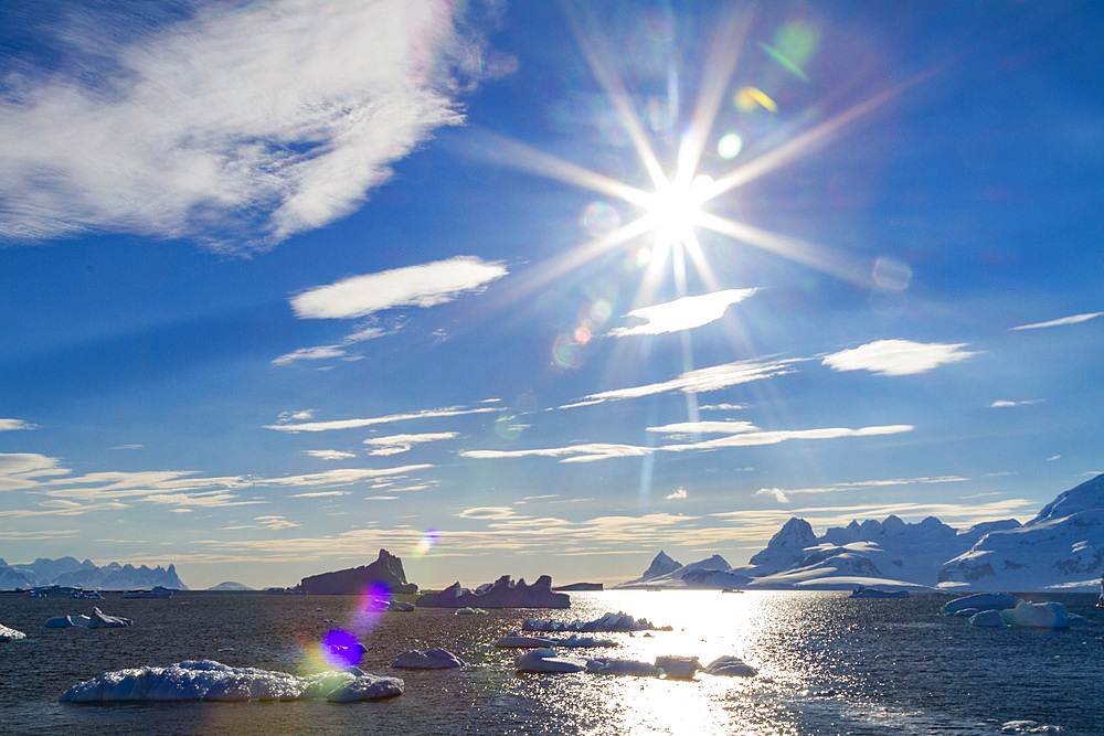 Icebergs surrounded by mountains in Paradise Bay, Antarctic Peninsula, Antarctica, Southern Ocean.
