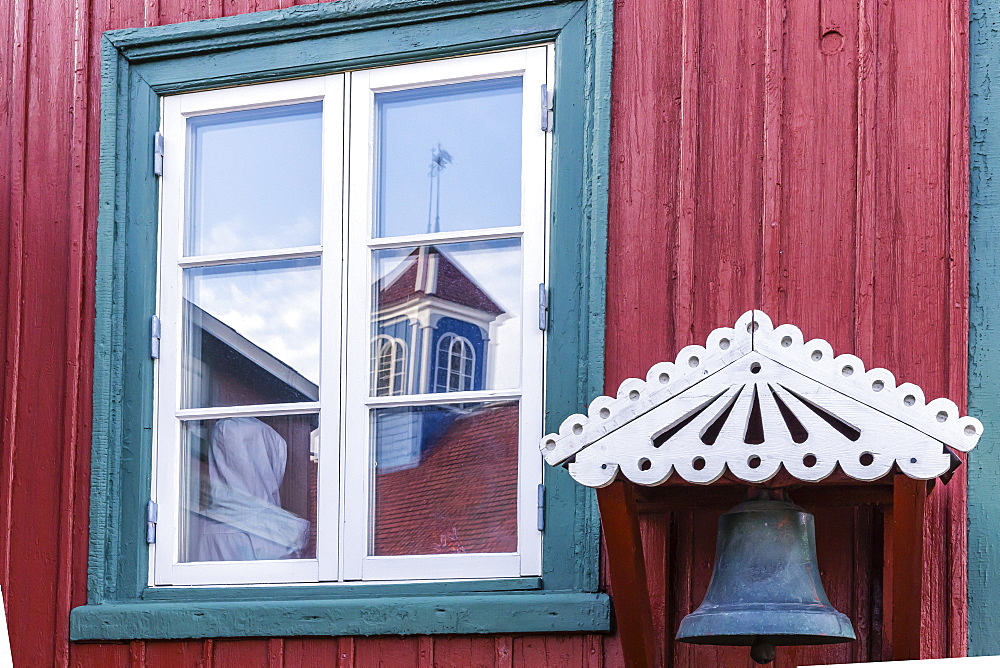 Brightly painted house reflected in window in Sisimiut, Greenland, Polar Regionscurve adjustments, boosted bluish shadows and rediish highlights