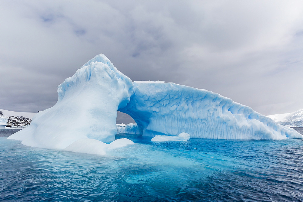 Archway formed in a glacial iceberg at Cierva Cove, Antarctica, Polar Regions