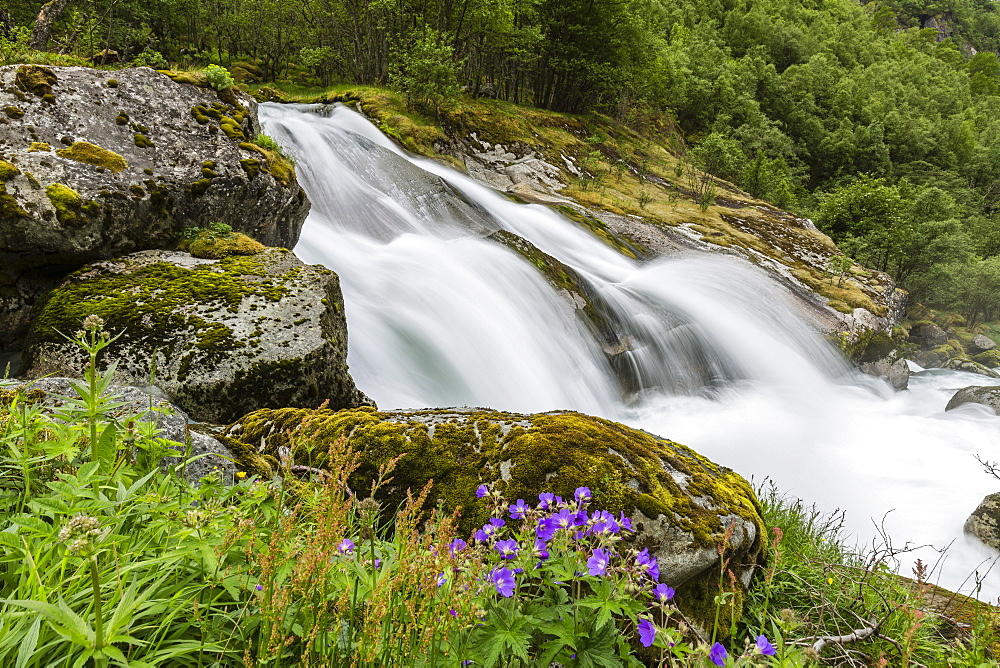 Slow shutter speed silky water of the Olden River as it flows along Briksdalen, Olden, Nordfjord, Norway, Scandinavia, Europe