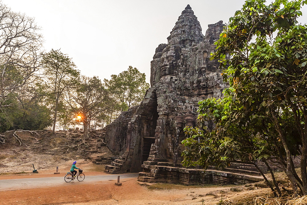 Bicycle going through the South Gate in Angkor Thom at sunrise, Angkor, UNESCO World Heritage Site, Siem Reap Province, Cambodia, Indochina, Southeast Asia, Asia