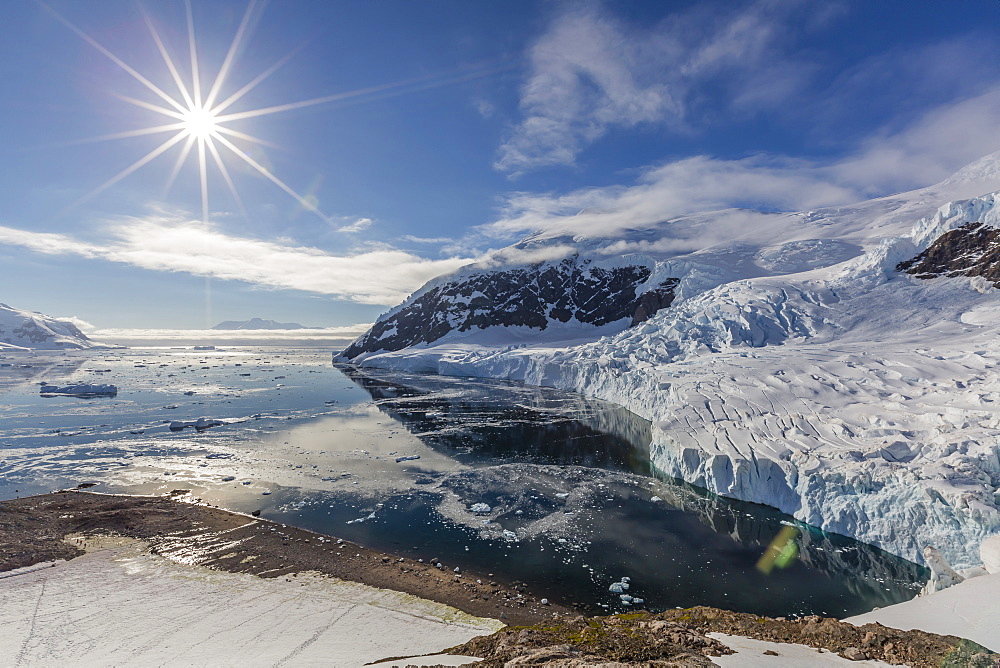 Ice choked waters surrounded by ice-capped mountains and glaciers in Neko Harbor, Antarctica, Polar Regions