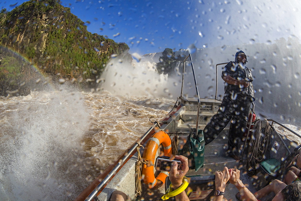 Tourists take a river boat to the base of the falls, Iguazu Falls National Park, UNESCO World Heritage Site, Misiones, Argentina, South America