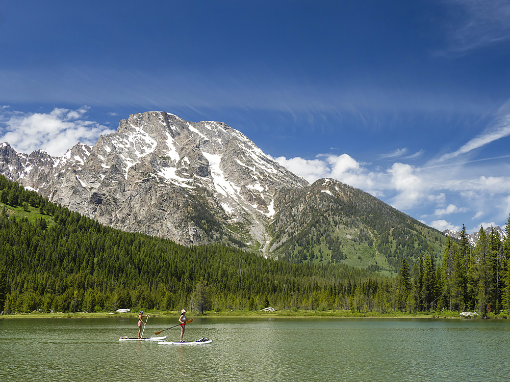 Stand up paddle boarders on String Lake, Grand Teton National Park, Wyoming, United States of America, North America