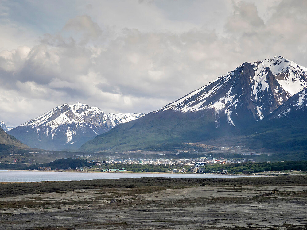 An aerial view of the snow-capped Andes Mountains surrounding the town of Ushuaia, Beagle Channel, Argentina, South America