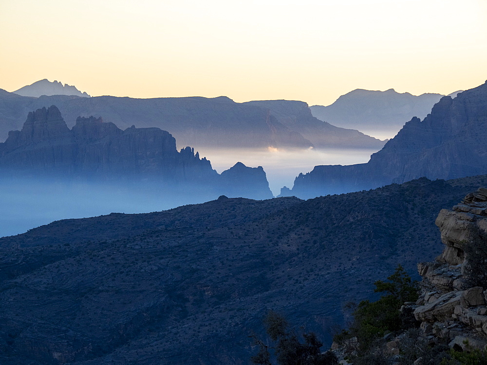 Low-lying clouds fill the valley at sunrise at Sharaf Al Alamayn, Sultanate of Oman, Middle East