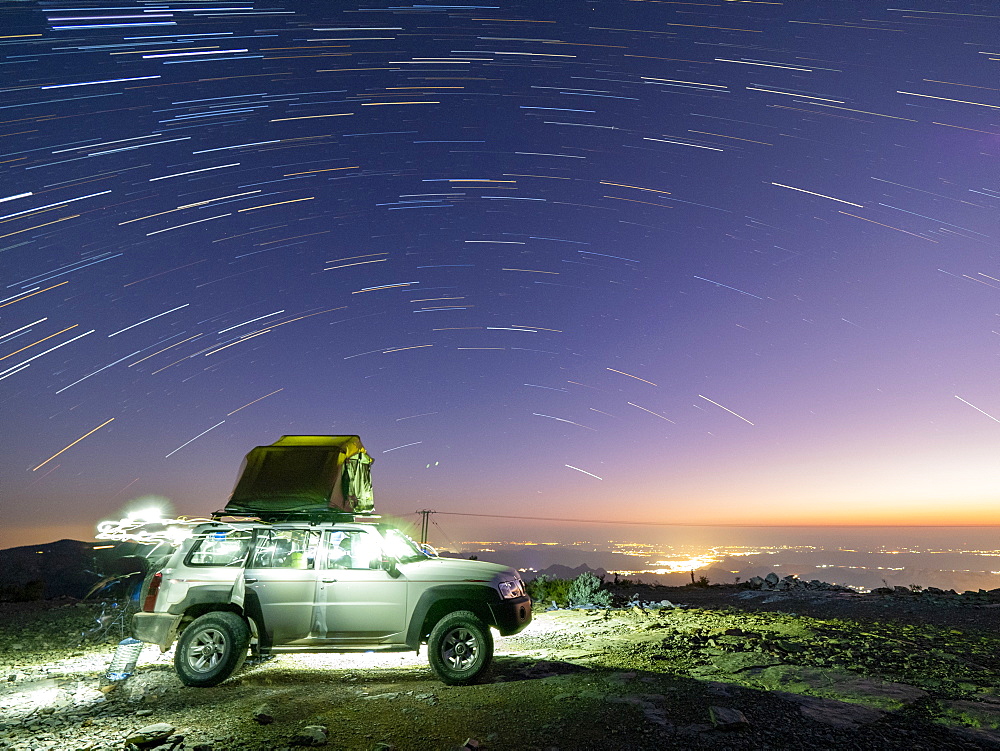 Star trails over truck camping site at Sharaf Al Alamayn, Sultanate of Oman, Middle East