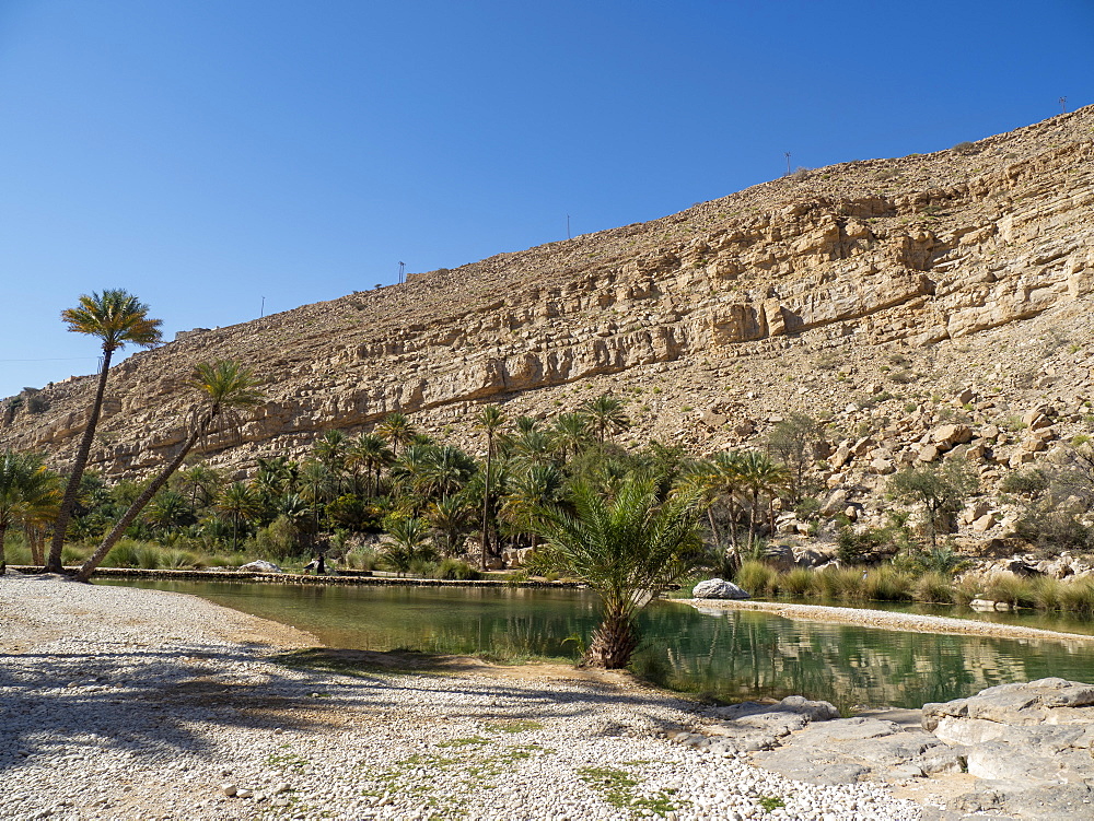 Natural swimming pools formed by flood waters in Wadi Bani Khalid, Sultanate of Oman, Middle East