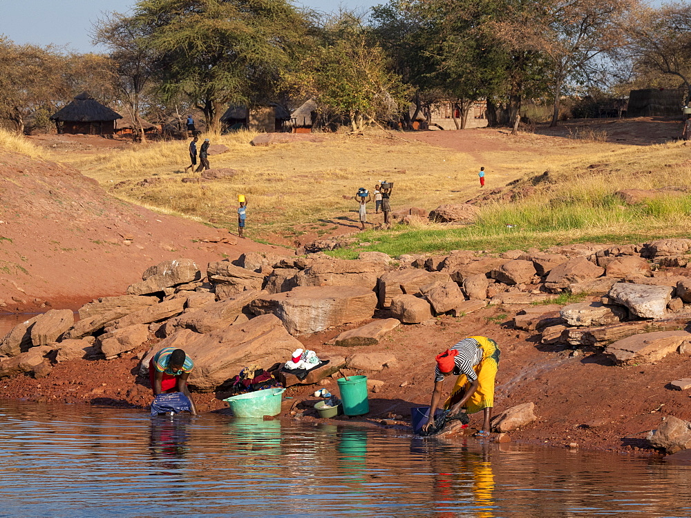 Women doing laundry in the fishing village of Musamba, on the shoreline of Lake Kariba, Zimbabwe, Africa