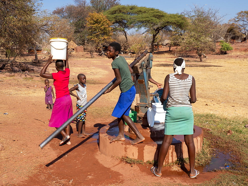 Pumping fresh water from a well in the fishing village of Musamba, on the shoreline of Lake Kariba, Zimbabwe, Africa