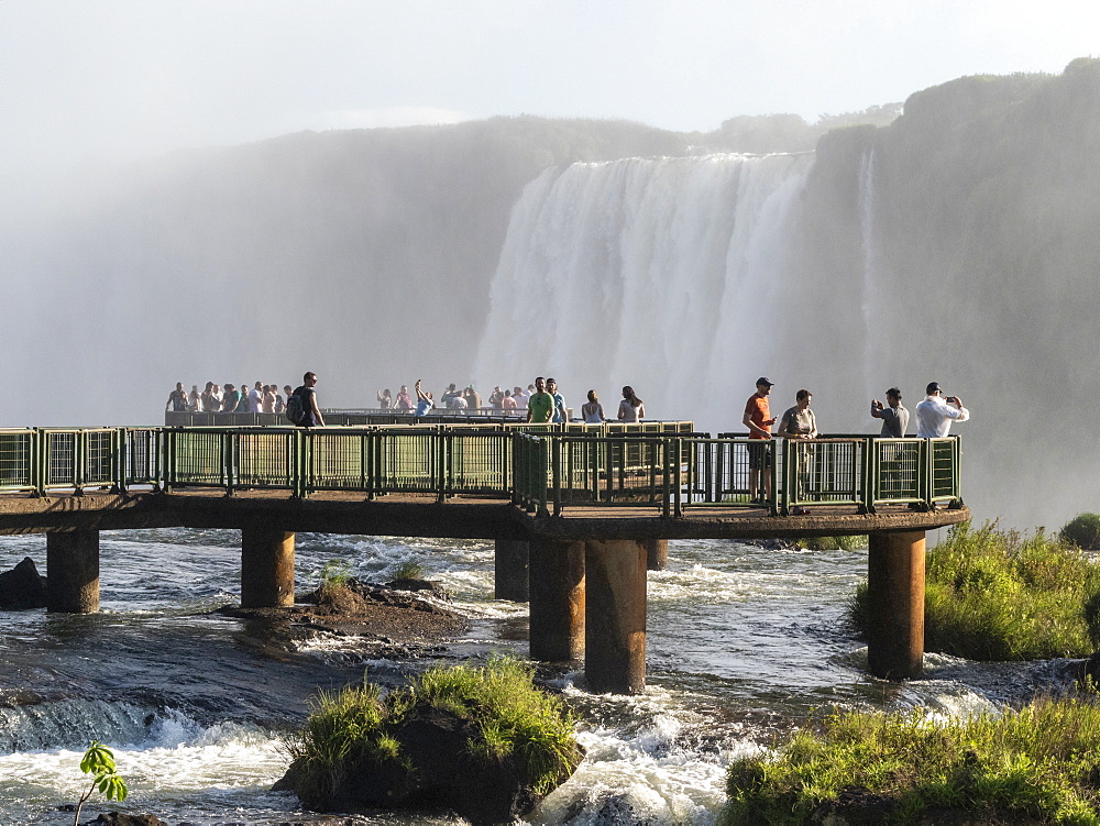 Tourists on viewing platform at Iguacu Falls (Cataratas do Iguacu), UNESCO World Heritage Site, from the Brazilian side, Parana, Brazil, South America