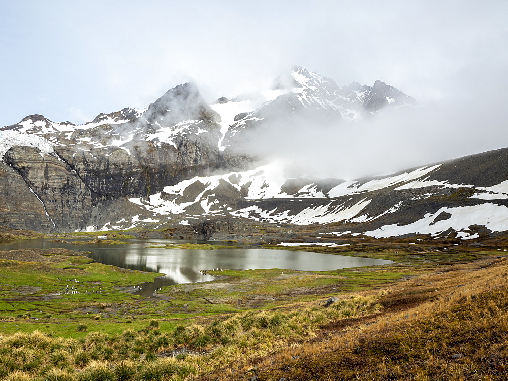 Snow-covered mountains and glacial meltwater lake in Gold Harbor, South Georgia, Polar Regions