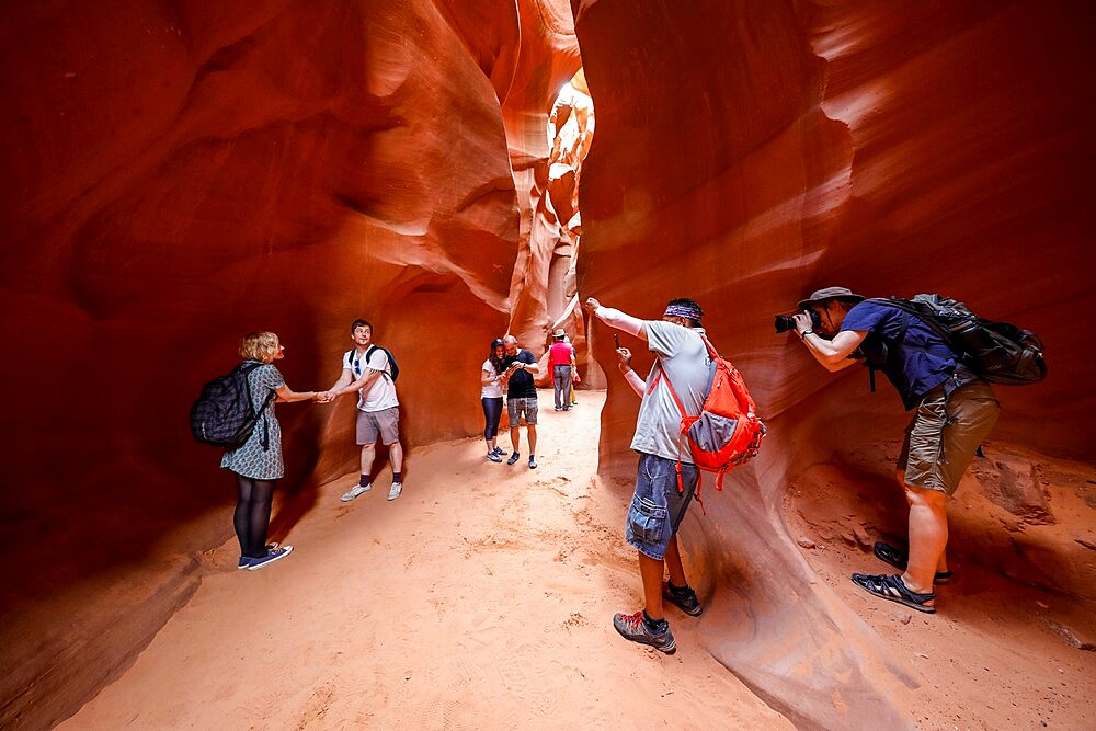 Tourists explore a slot canyon in Upper Antelope Canyon, Navajo Land, Arizona, United States of America, North America