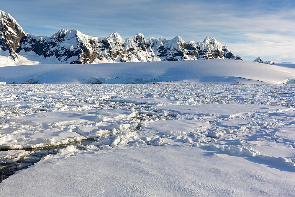 Snow-covered mountains and dense sea ice in Neumayer Channel, Palmer Archipelago, Antarctica, Polar Regions