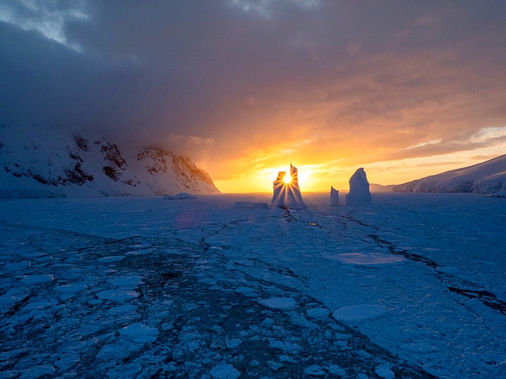 Sunset over an unusual iceberg near Petermann Island, Antarctica, Polar Regions