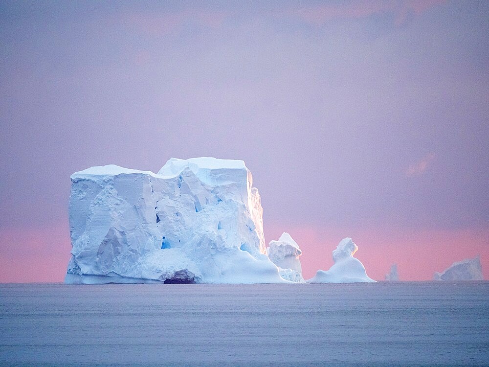 Sunset on a large iceberg at sea towards Peter I Island, Bellingshausen Sea, Antarctica, Polar Regions