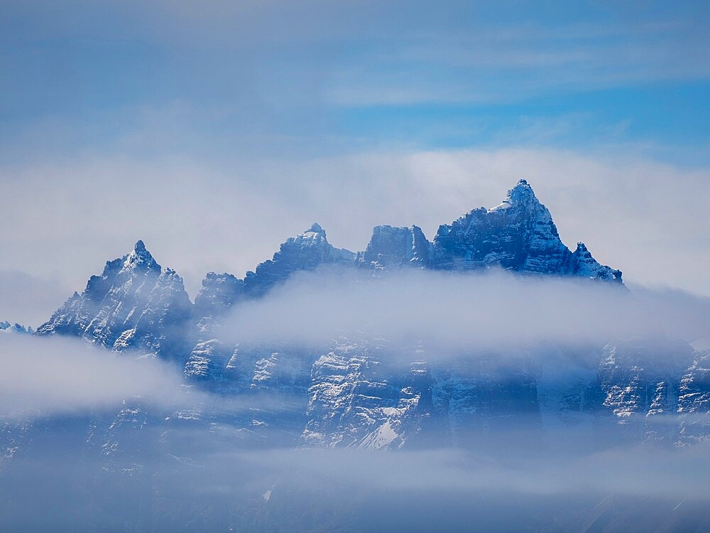 Fog obscures the rugged mountains and glaciers of the south side of the South Georgia coastline, South Georgia, South Atlantic, Polar Regions