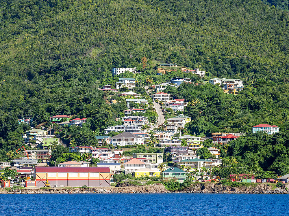 A view from the sea of the lush mountains surrounding the capital city of Roseau, on the west coast of Dominica, Windward Islands, West Indies, Caribbean, Central America