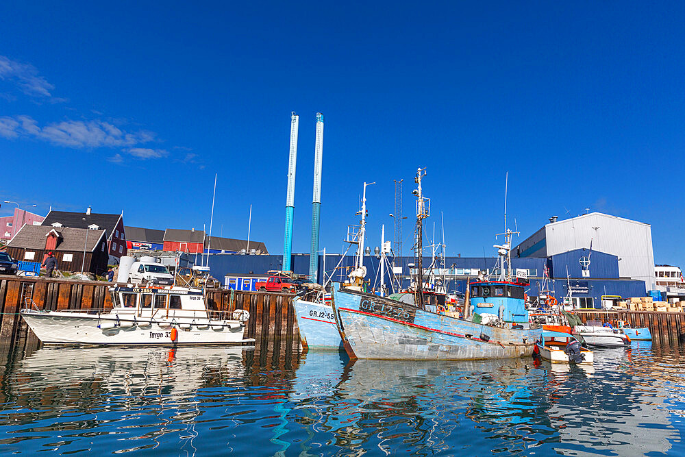 A view commercial fishing and whaling boats in the inner harbor in the city of Ilulissat, Greenland, Denmark, Polar Regions