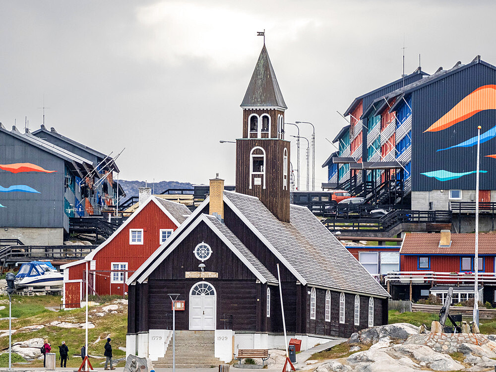 A view of Zion's Church surrounded by colorfully painted houses in the city of Ilulissat, Greenland, Denmark, Polar Regions