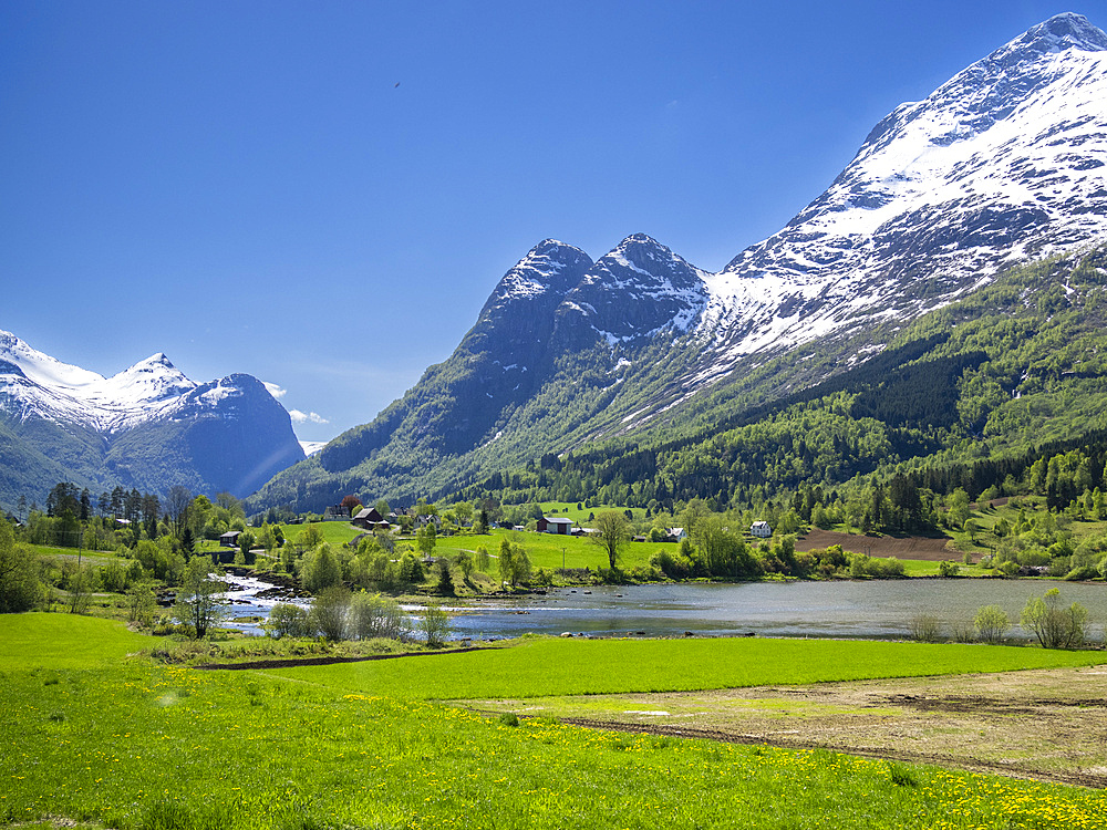 A view of houses along the shore of Lake Oldevatnet, within the Oldedalen River Valley, Vestland, Norway, Scandinavia, Europe