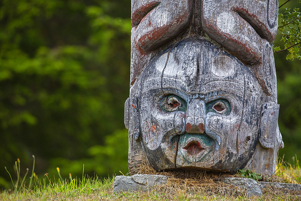 Kwakwaka'wakw totem poles in the cemetery in Alert Bay, Cormorant Island, British Columba, Canada.