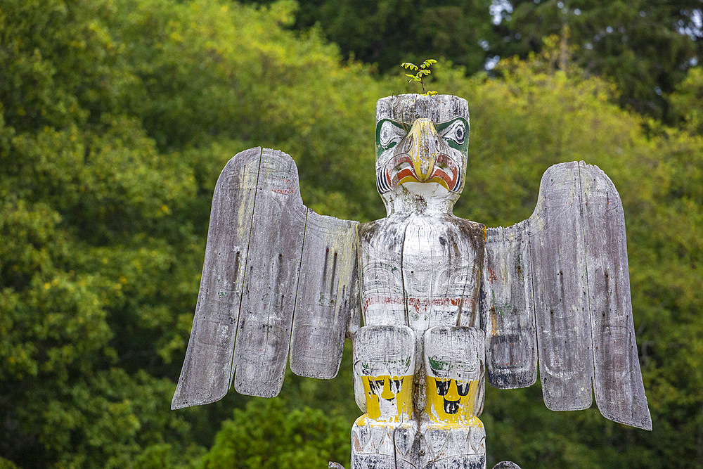 Kwakwaka'wakw totem poles in the cemetery in Alert Bay, Cormorant Island, British Columba, Canada.