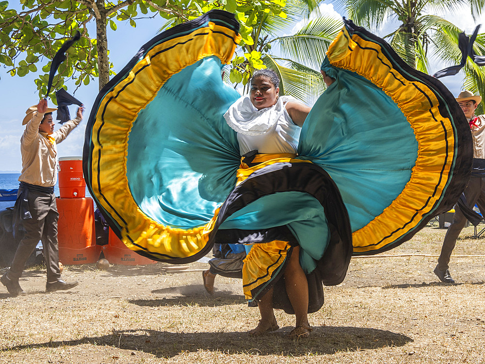 A group of young Costa Rican dancers in traditional dress perform at Playa Blanca, El Golfito, Costa Rica, Central America