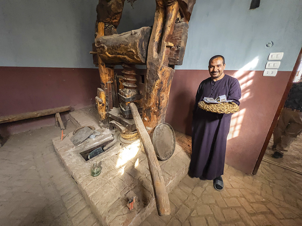 An Egyptian man at a wine press located in the heart of the city of Dendera, Egypt, North Africa, Africa