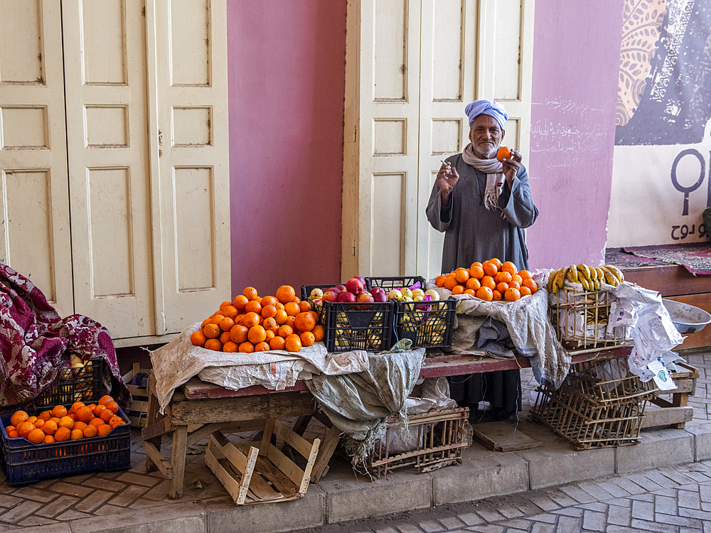 An old Egyptian vendor with his wares in the heart of the city of Dendera, Egypt, North Africa, Africa