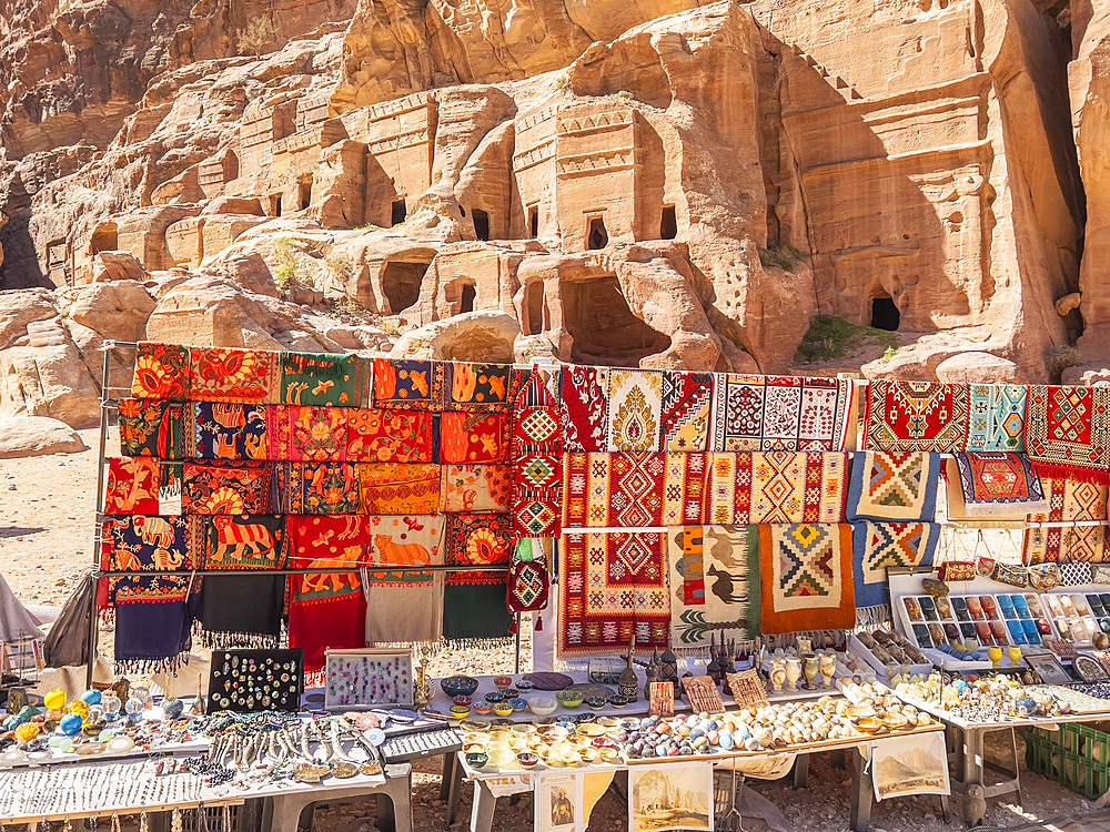 Shawls and rugs for sale at the Street of Facades, Petra Archaeological Park, UNESCO World Heritage Site, one of the New Seven Wonders of the World, Petra, Jordan, Middle East