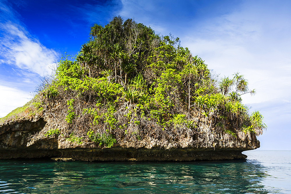 A view of islets covered in vegetation from inside the natural protected harbor in Wayag Bay, Raja Ampat, Indonesia, Southeast Asia, Asia