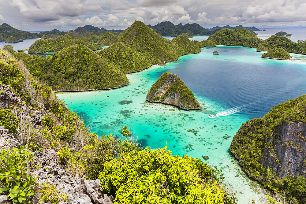 A view from on top of the small islets of the natural protected harbor in Wayag Bay, Raja Ampat, Indonesia, Southeast Asia, Asia