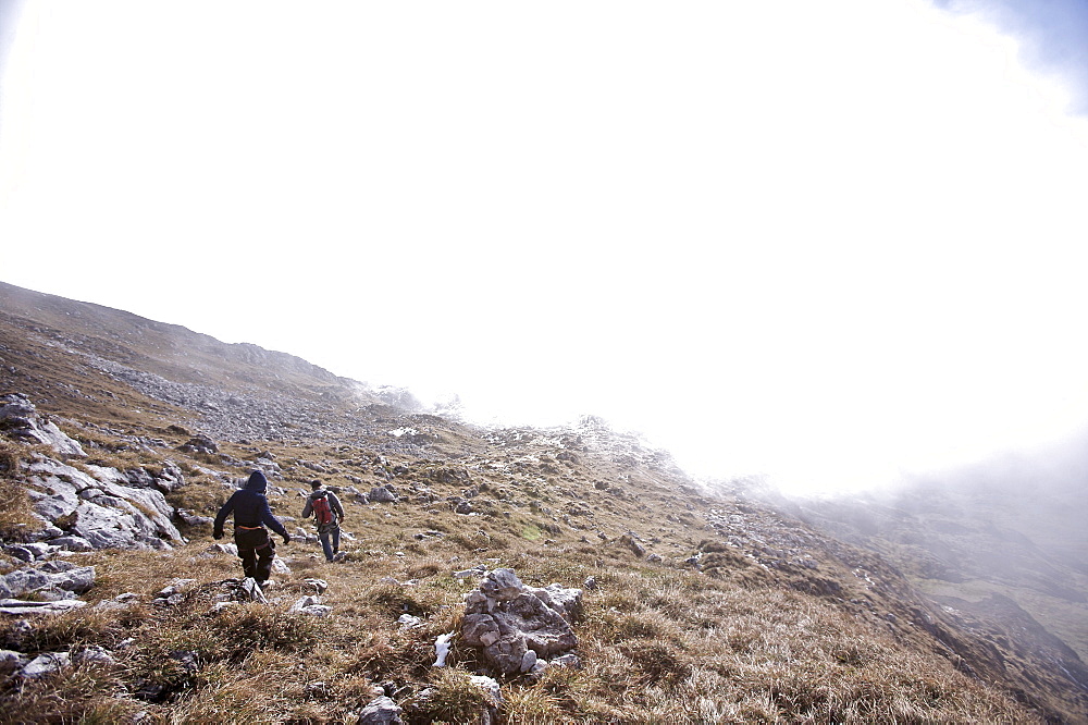 Two people hiking through a mountain scenery, Oberstdorf, Bavaria, Germany