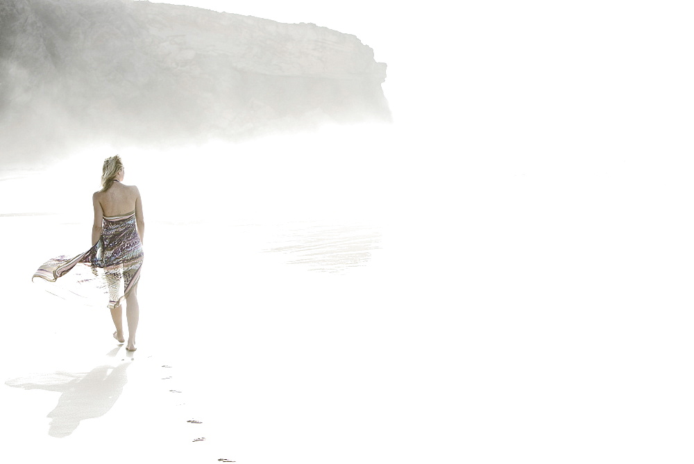 Young woman walking at the beach, Fuerteventura, Spain