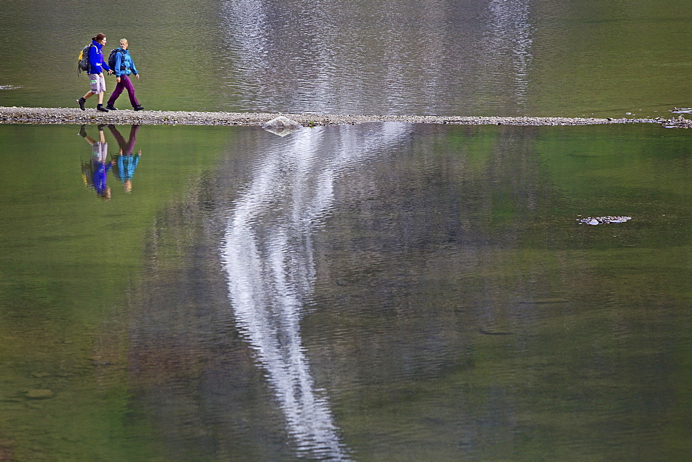 Two female hikers crossing Lake Faaker, Carinthia, Austria