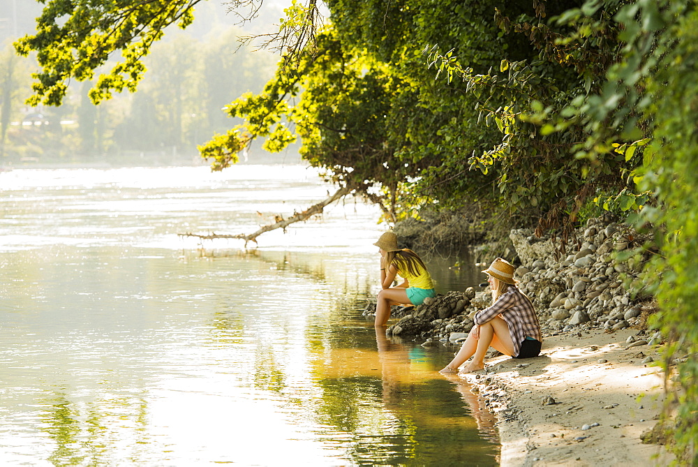 Two young women at river Rhine, Rheinfelden, Baden-Wuerttemberg, Germany