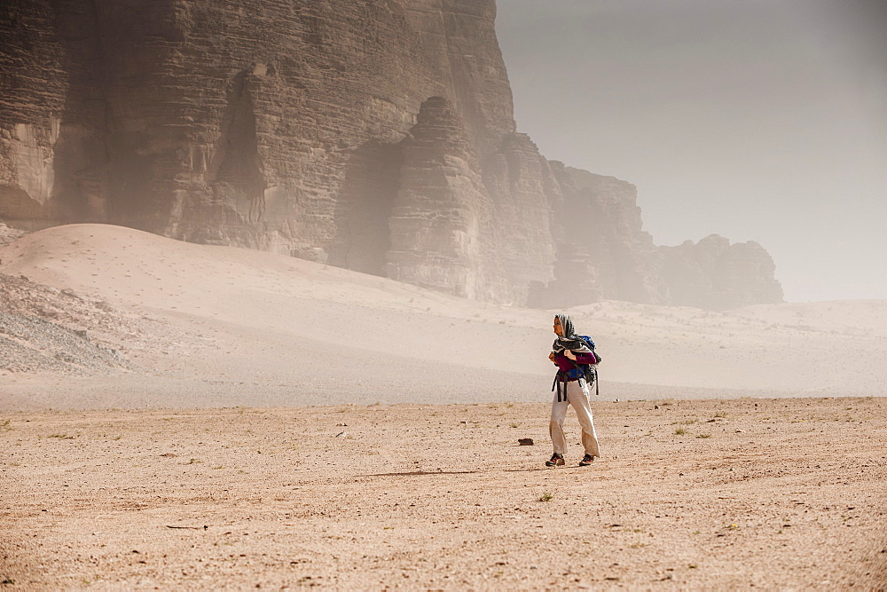 Woman hiking through desert scenery, Wadi Rum, Jordan, Middle East