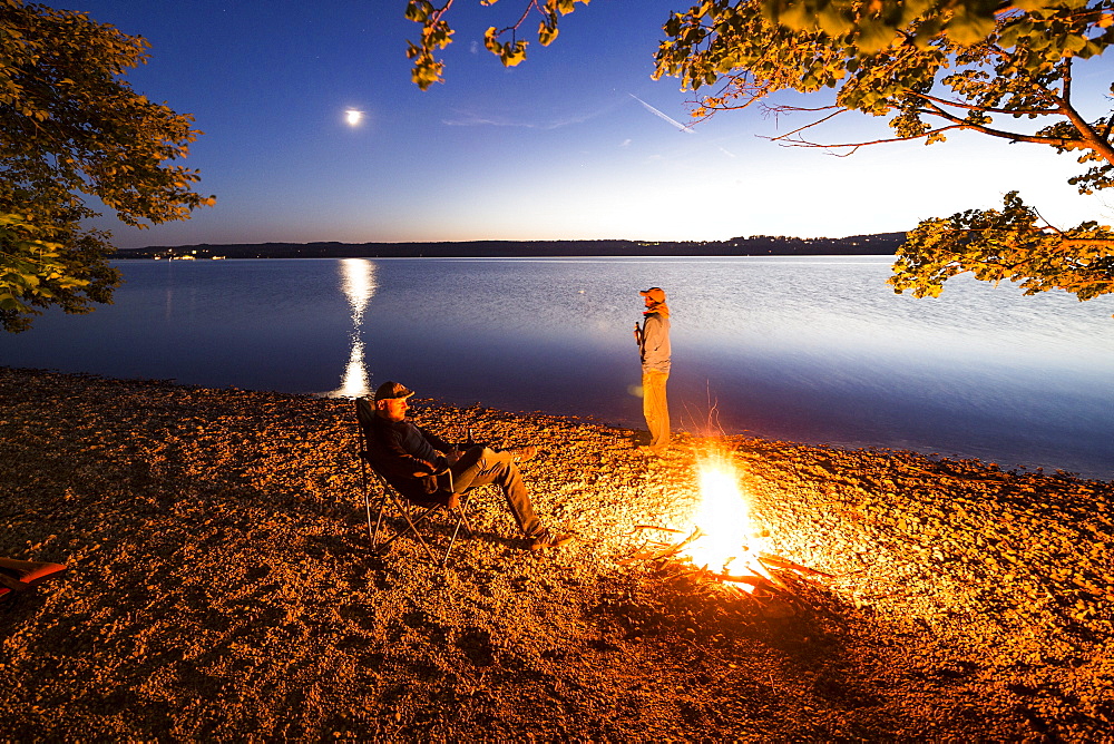 Two men at a campfire, Lake Starnberg, Berg, Upper Bavaria, Germany