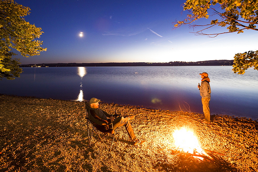 Two men at a campfire, Lake Starnberg, Berg, Upper Bavaria, Germany