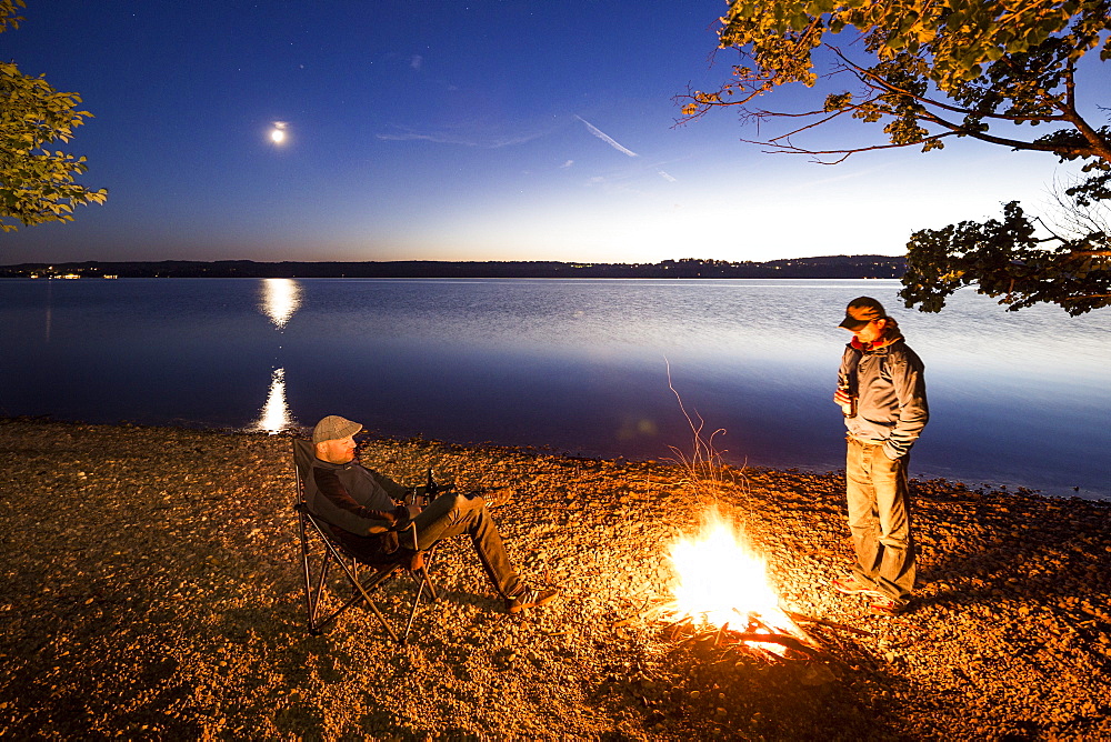 Two men at a campfire, Lake Starnberg, Berg, Upper Bavaria, Germany