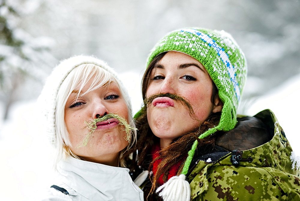 Two young women with fake beards