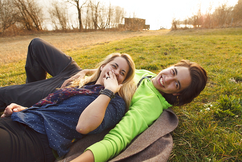 Young couple on a blanket, Grosser Alpsee, Immenstadt, Bavaria, Germany