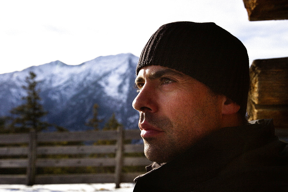 Man looking into the distance, alpine hut, descent from Unnutz Mountain (2078 m), Rofan Mountains, Tyrol, Austria