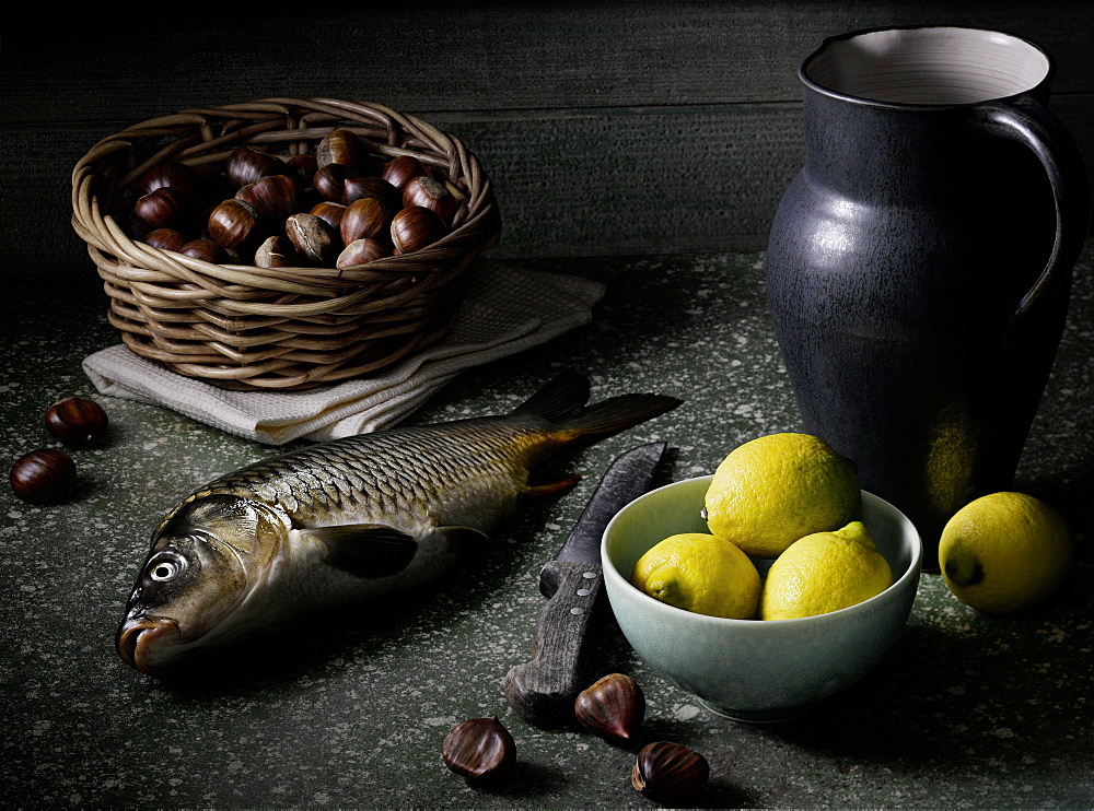 Still life with carp, lemons and chestnut